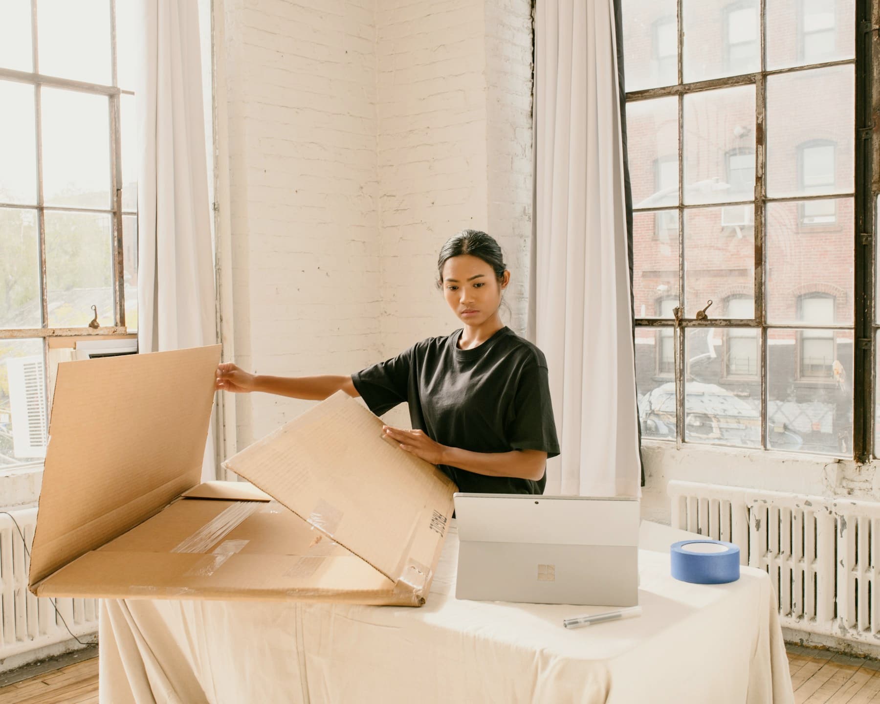 Operator packing customer orders beside a laptop