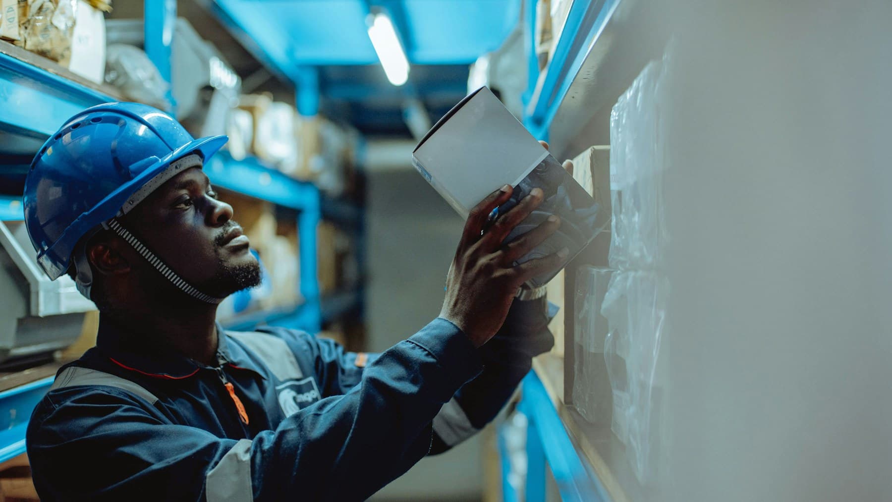 Regulated inventory worker scanning a shelf in a warehouse