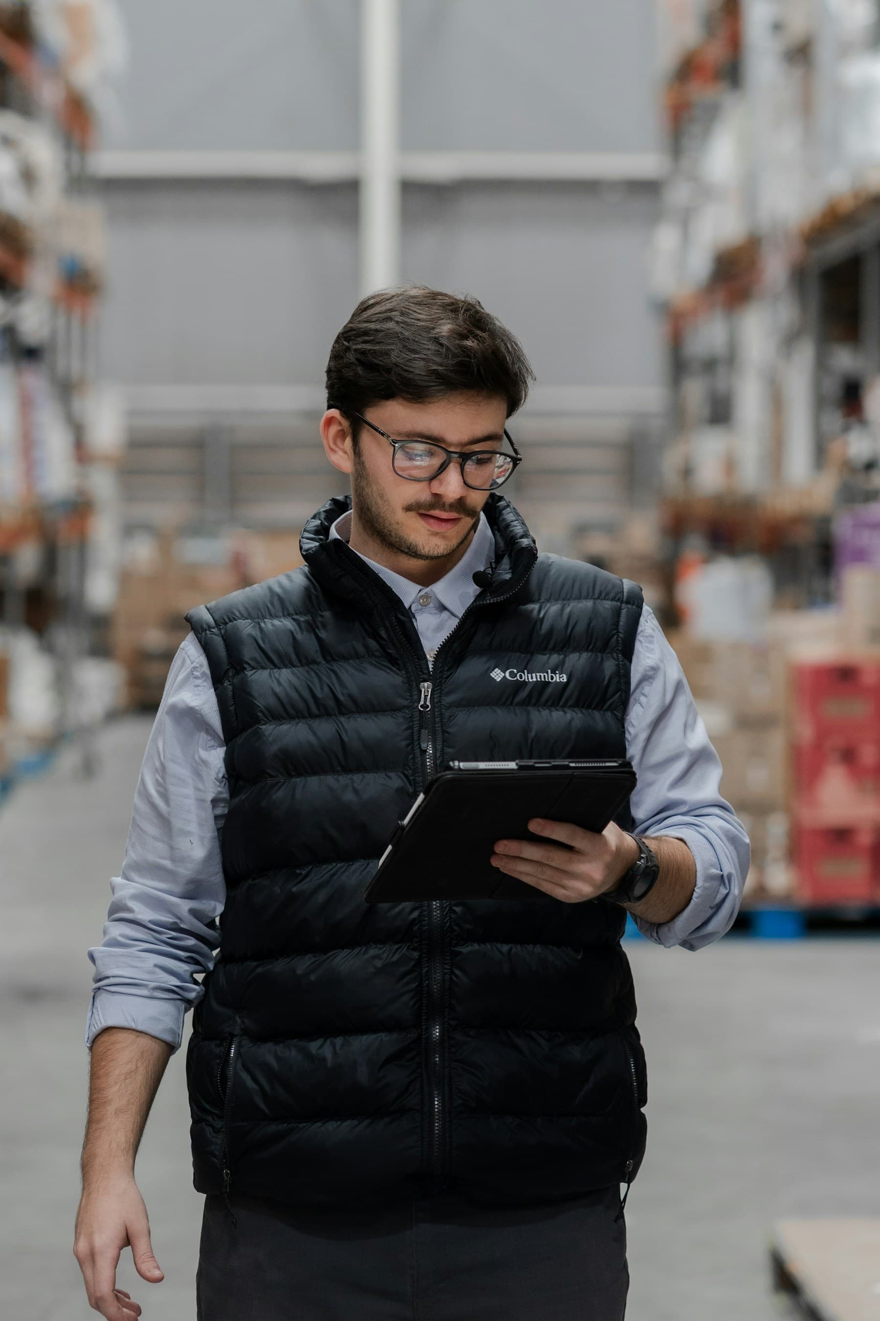 Warehouse operator reviewing a purchase order on a tablet